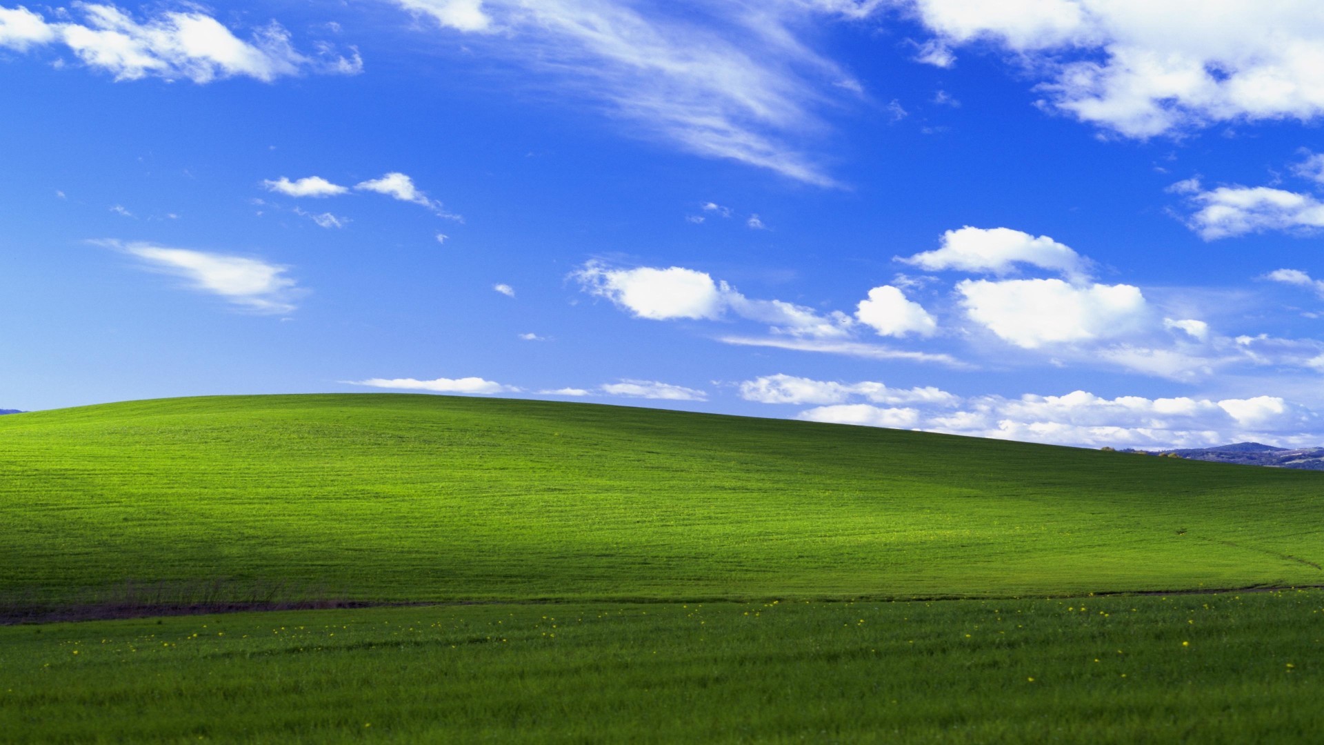 Green hills beneath a blue sky